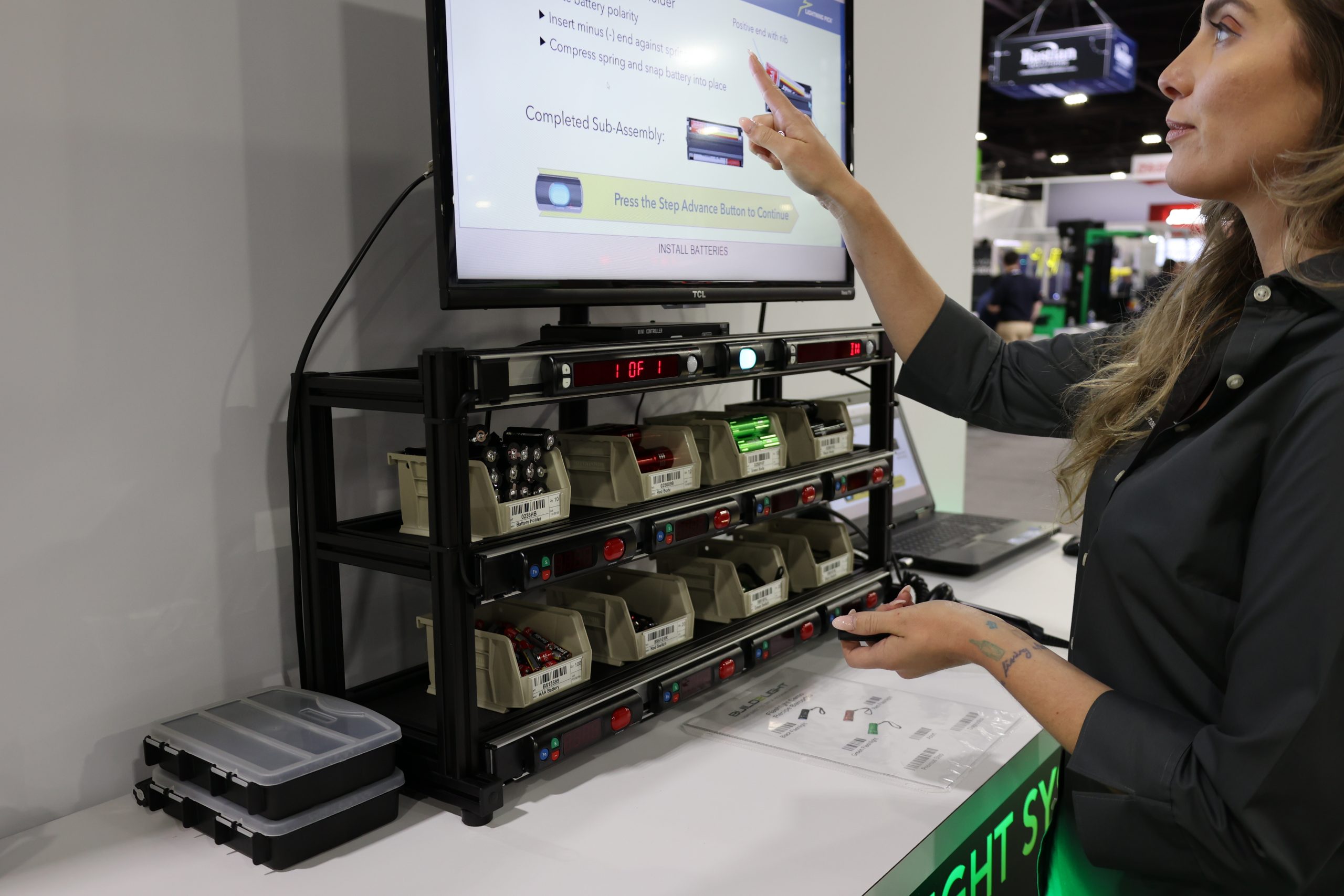 Operator performing kitting demo in a trade show booth