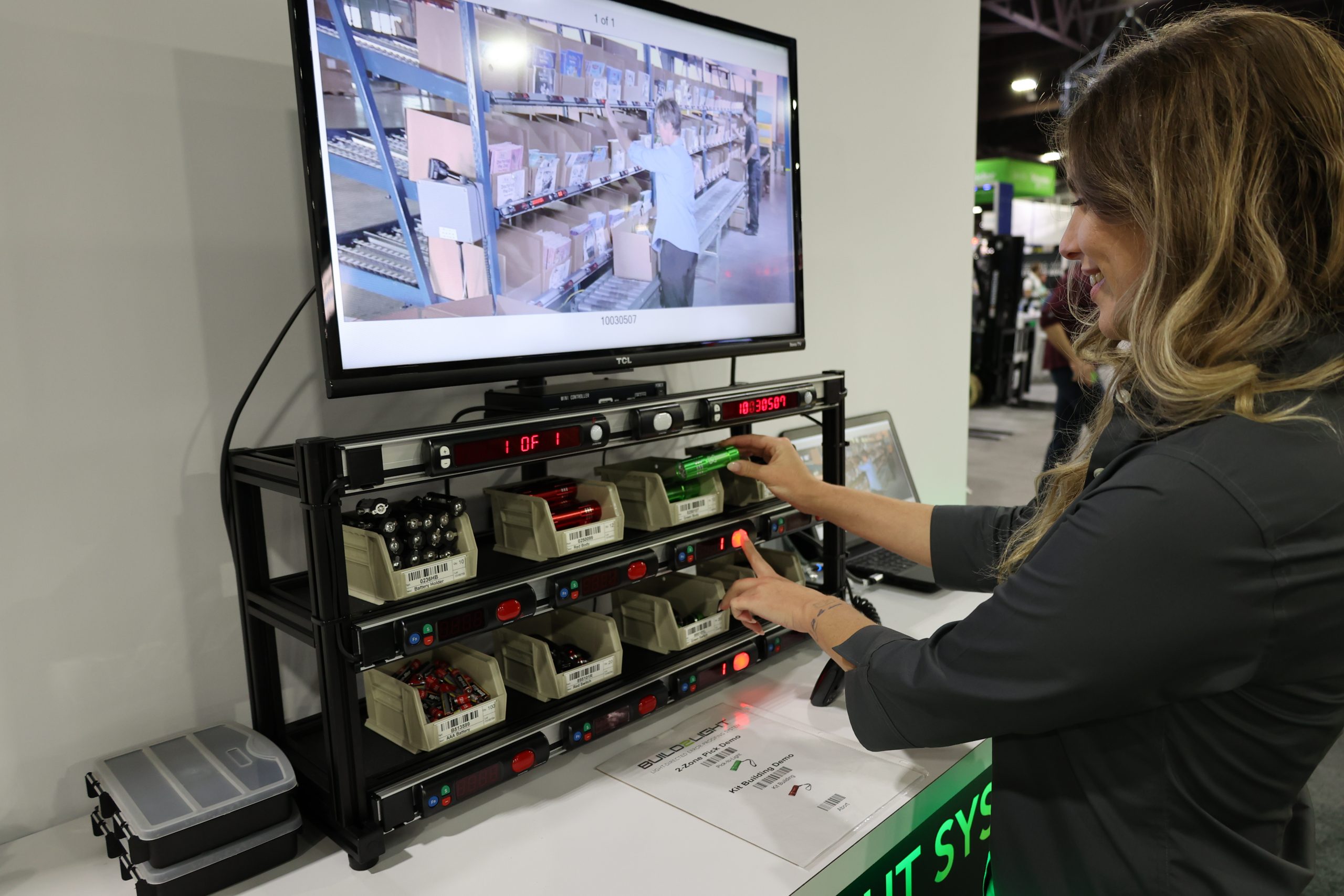 Operator performing pick-to-light demo in a trade show booth