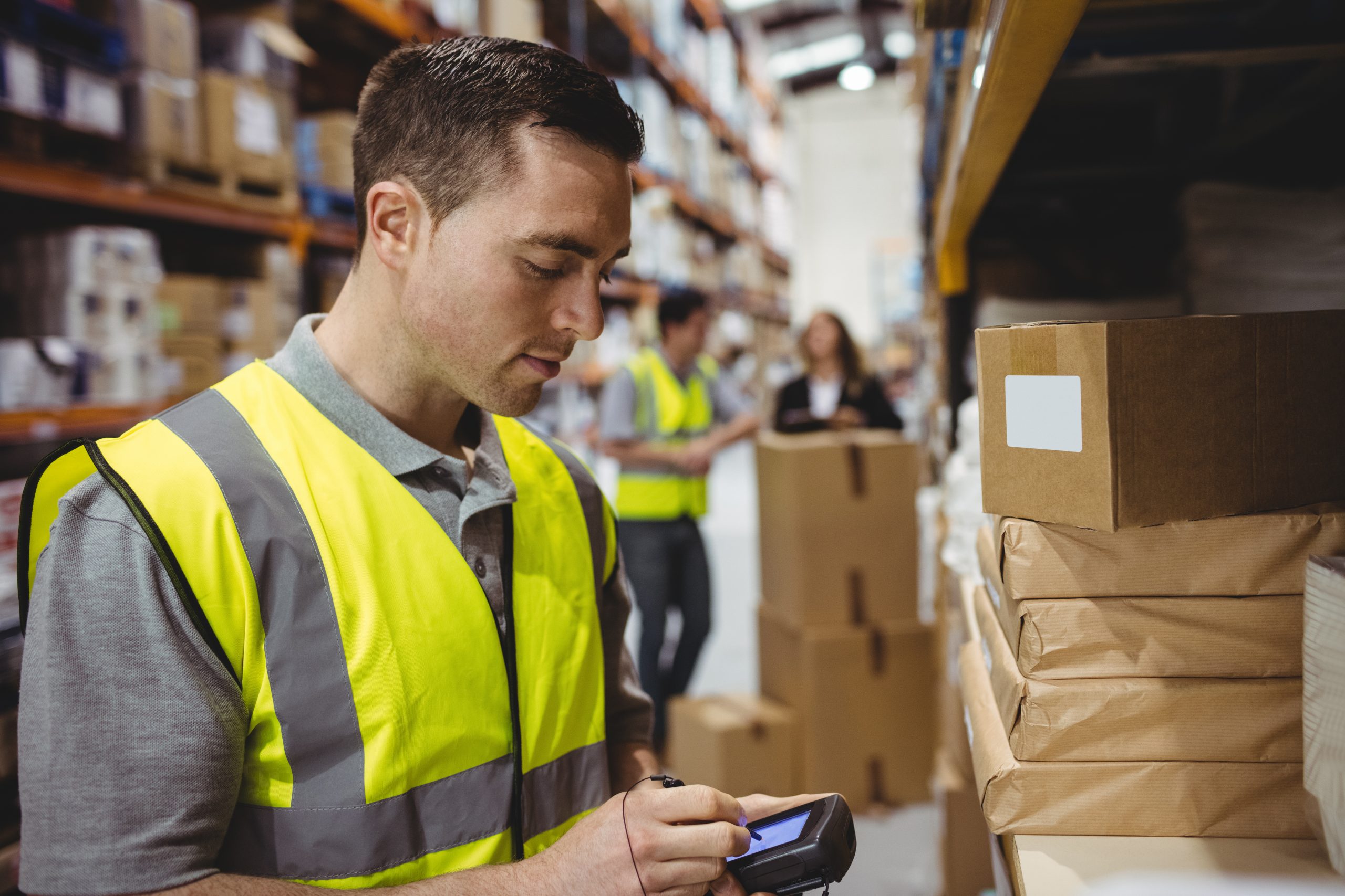 Warehouse worker uses RF terminal to pick orders