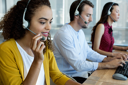 customer service representatives talking on headsets