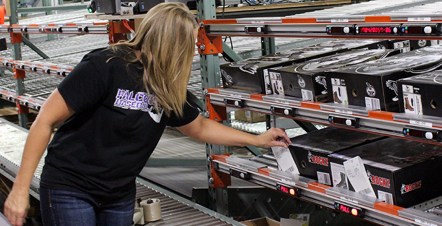 Woman Sorting Orders with a Put Wall System