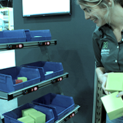 woman picking from goods-to-person AMR drop off