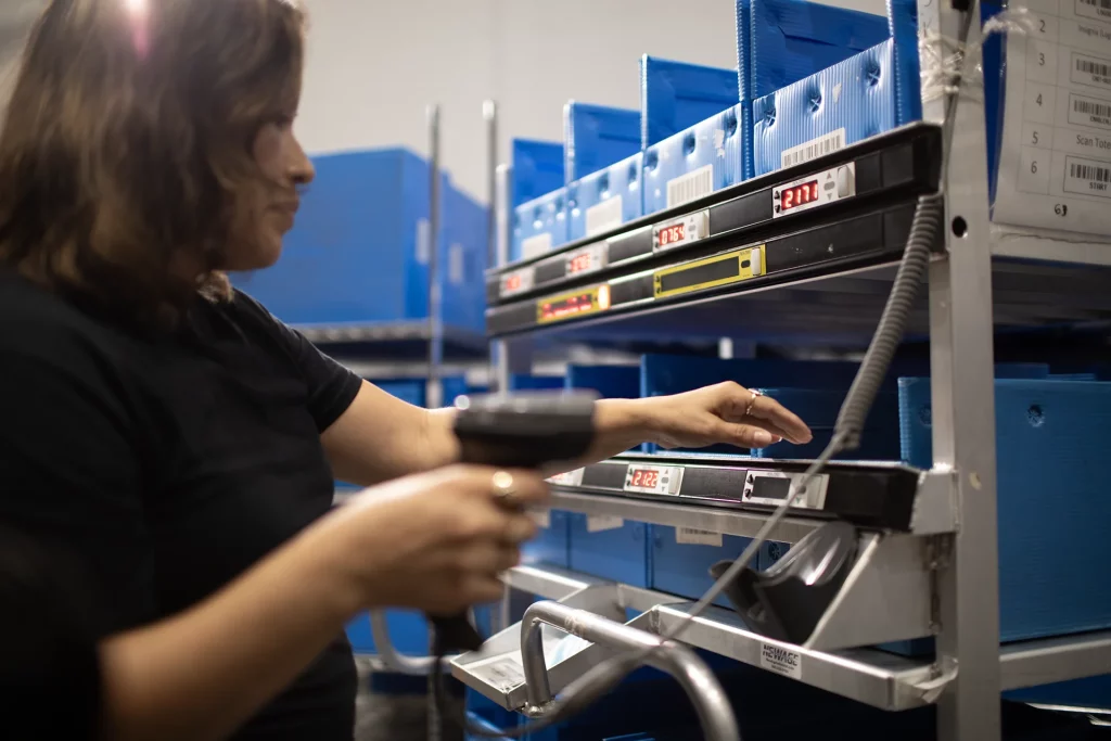 Woman using a picking cart. For light directed systems blog at 3PLs.