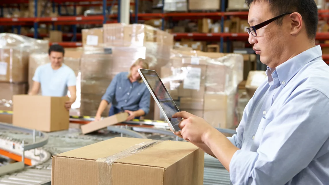 man with tablet in ecommerce fulfillment center